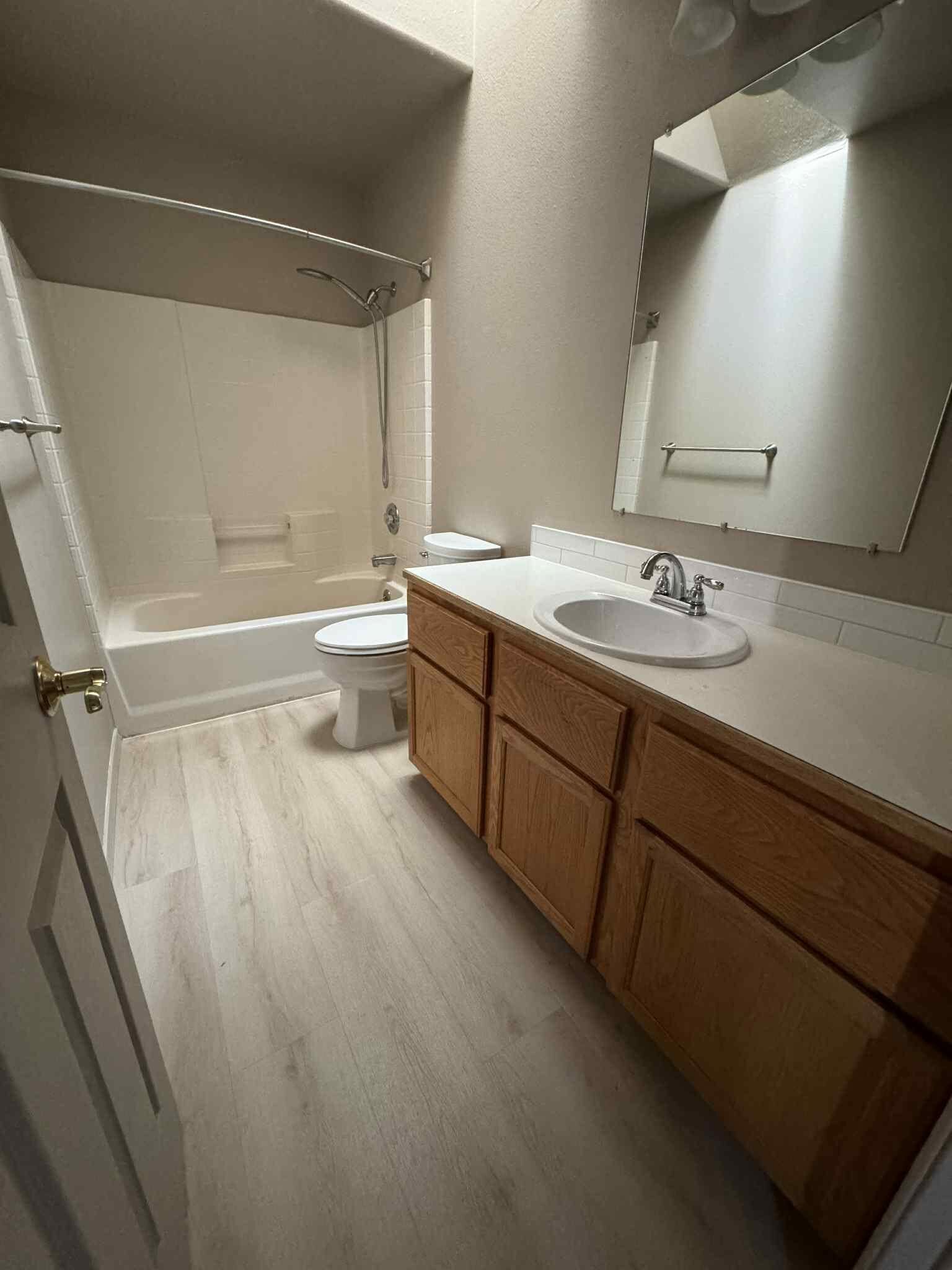 Bathroom with waterproof luxury vinyl plank flooring installed by MG Flooring