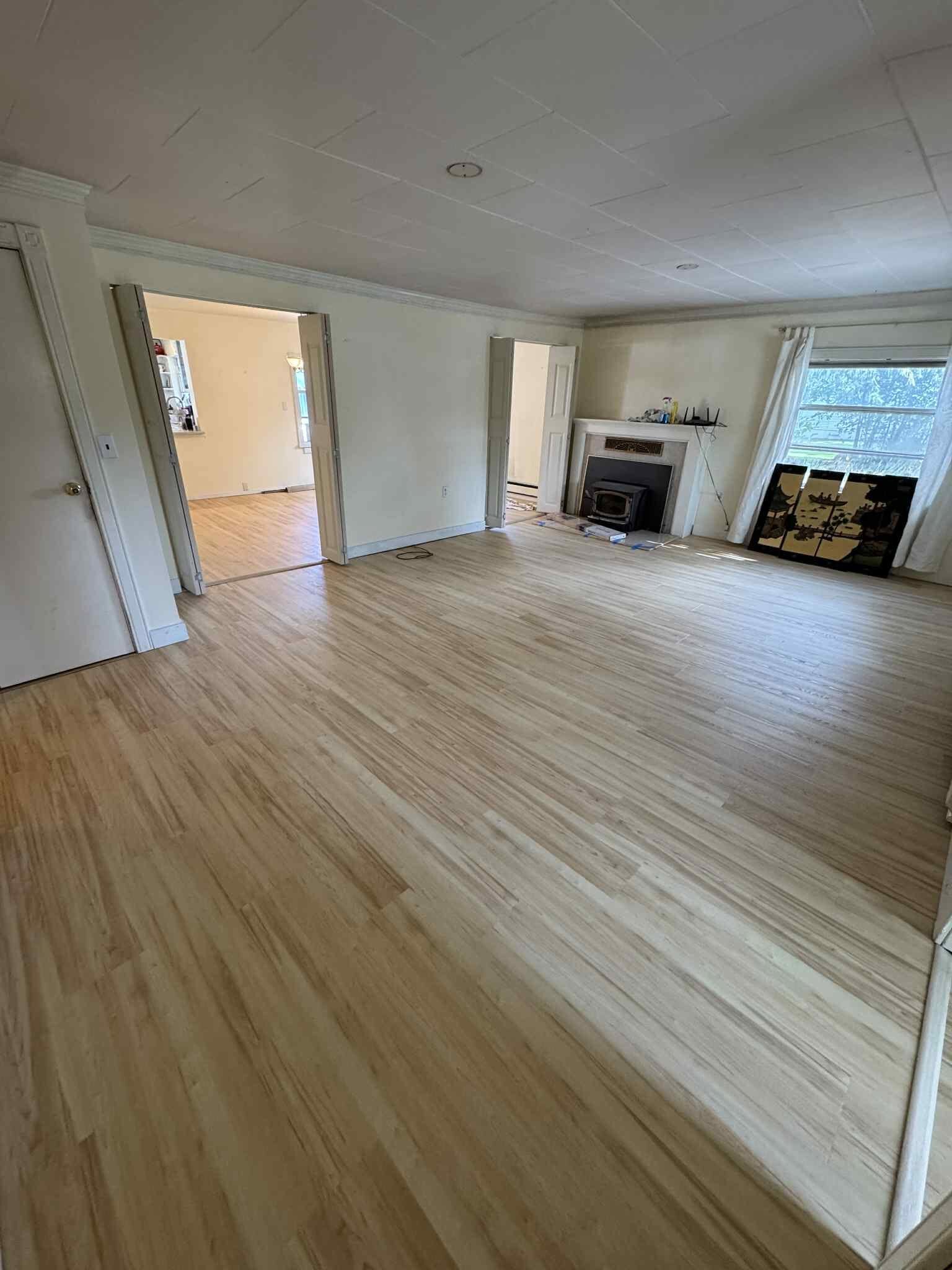 Hardwood living room floor with fireplace installed by MG Flooring