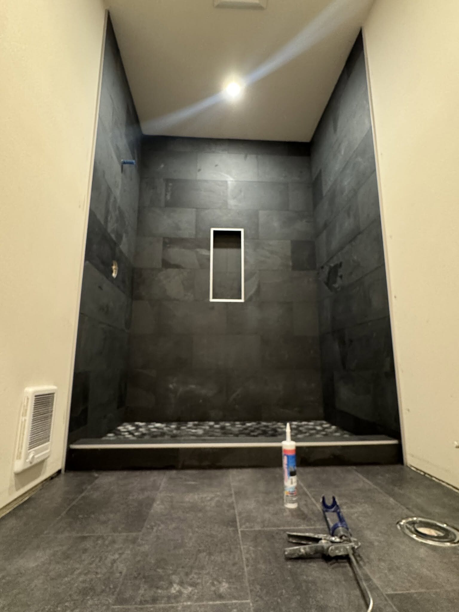 Dark slate tile shower installed by MG Flooring